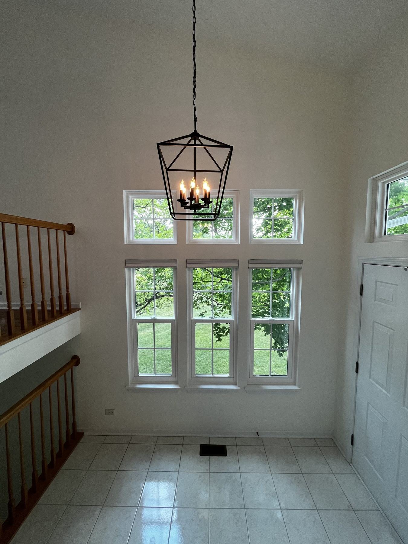 Two-story entryway foyer painted white