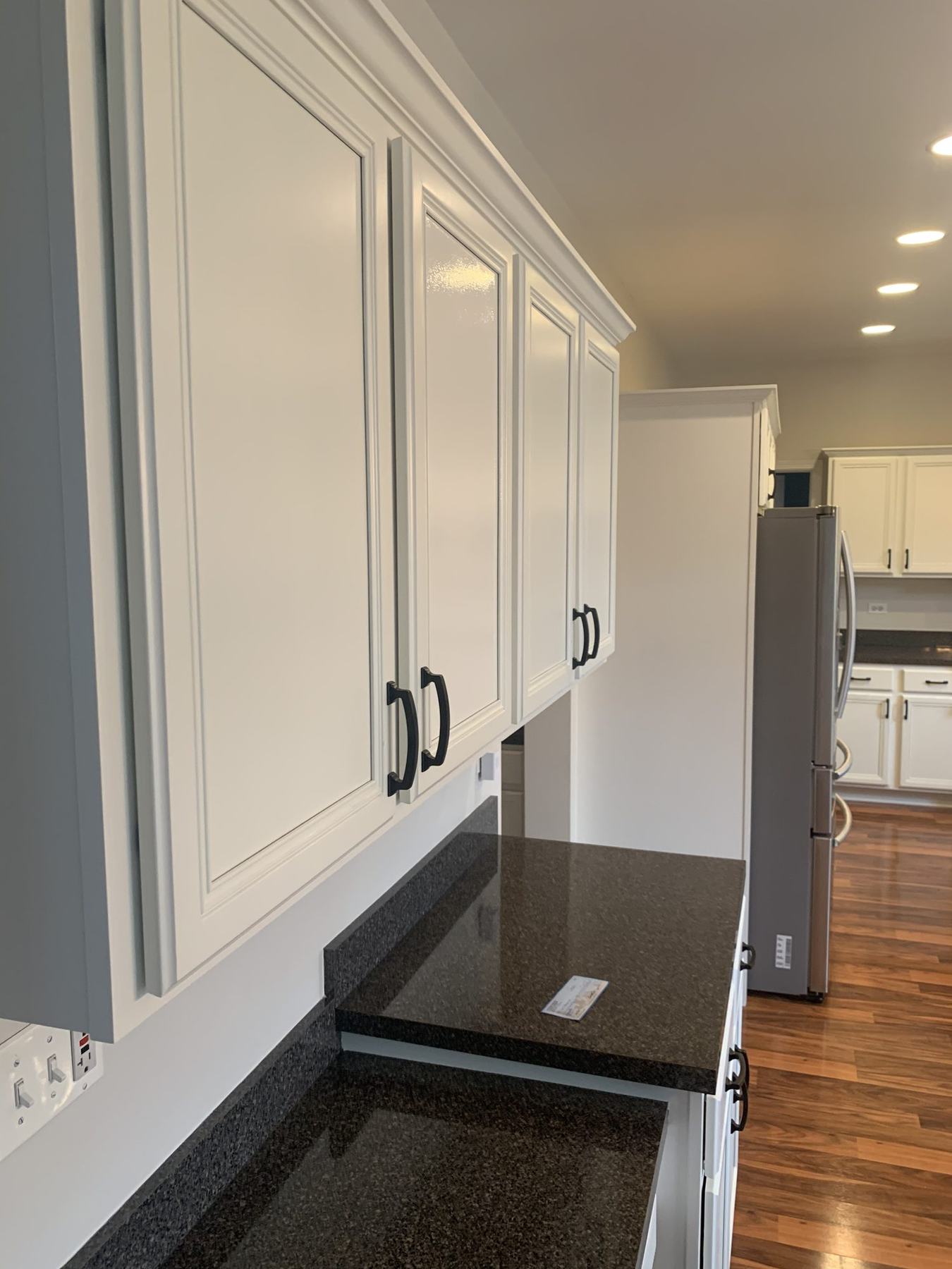 Close detail of kitchen cabinets refinished in white