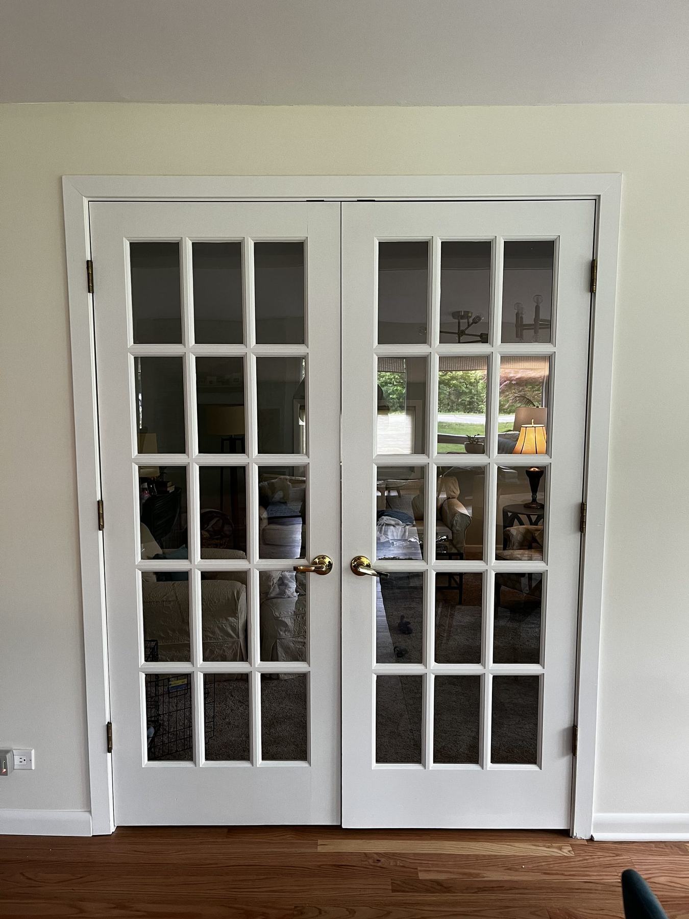 Living room with white french doors and trim after repainting