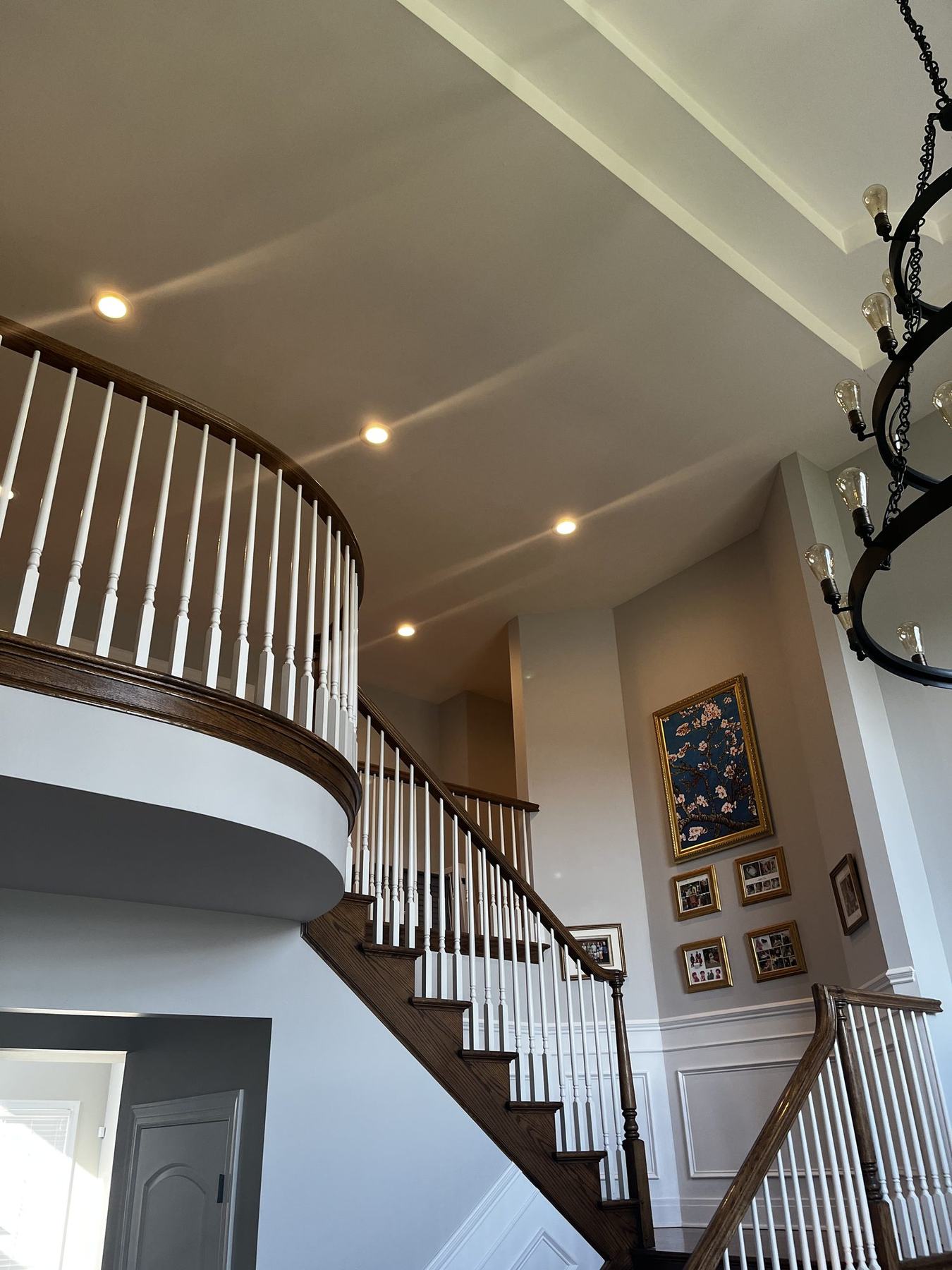 Two-story stairwell with repainted ceiling, trim and wainscoting
